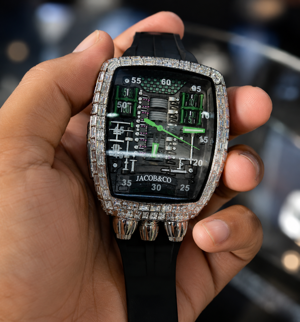 Luxury Jacob & Co watch with diamond-studded case held in a hand against a blurred background